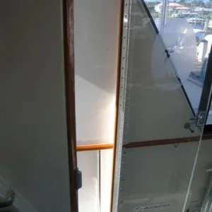 Piano hinge screwed to frame and acrylic