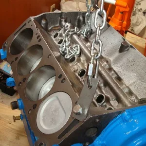 The block is ready to be lowered into the engine compartment